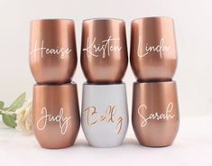 six wine glasses with names on them sitting next to each other