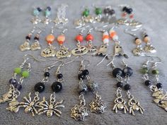 These antique silver Halloween charm earrings are perfect the spooky season. Choose from ghosts, pumpkins, jack-o-lanterns, witches and spiders. Most of my items can be customized.  If you see something you like but want a different color or some other change, contact me and I will see what I can do. Due to the nature of handmade items, each item is unique and may vary slightly from the photos. | Production Time | All items are handmade and made to order. I try to ship the items out within 3 days. All orders are shipped in order of sale received. If you need an item right away, please contact me and I will make every effort to accommodate your needs. | Social Media | Follow me on Facebook for new designs, updates, giveaways, and sales/promos: facebook.com/CreativQuirks Thank you for visiti Beaded Spiders, Witch Earrings, Spider Earrings, Diy Jewelry Unique, Witch Jewelry, Halloween Charms, Brick Stitch Pattern, Goth Jewelry, Zipper Charms