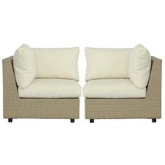 a pair of beige wicker couches with white pillows