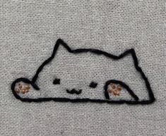 a cat embroidered on the back of a white shirt