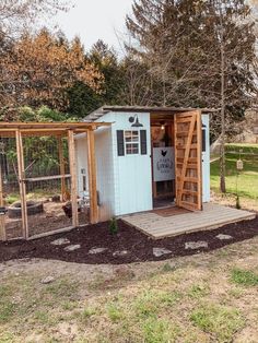 a chicken coop built into the side of a yard with steps leading up to it