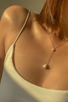 Warm glow on our Elle lariat necklace featuring gold filled chain with freshwater pearls — can wear it in the shower? Check!