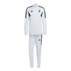 a white adidas suit with black stripes on the chest and bottom, in front of a