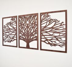 three metal wall art pieces depicting a tree