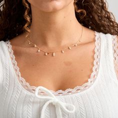 Tiny freshwater pearls adorn this dainty gold filled chain. They are tiered in a 3-2-1 count to create a layering effect. These pearls are tiny and off round. They are freshwater pearls so slight differences are to be expected. - Tiny 2-3mm roundish freshwater pearls- 14K Gold filled chain and clasp Dainty Pearl Necklace For Layering With Pearl Chain, Dainty Pearl Necklace For Layering, Delicate Pearl Necklace For Layering, Dainty Layering Jewelry With Pearl Drop, Dainty White Layered Pearl Chain Necklace, Delicate Pearl Pendant Charm Necklace, Dainty Pearl Necklace With Pearl Chain, Dainty Pearl Chain Layered Necklace, Dainty 14k Gold Filled Charm Necklace With Pearl Pendant