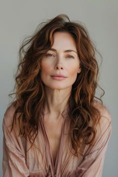 Embrace a fresh, carefree vibe with tousled waves and long layers. This hairstyle is ideal for mid-50s women who want to showcase their youthful spirit and natural charm. Click here to find additional hairstyles that can help you achieve a relaxed, yet stylish appearance with minimal effort. Tousled Waves, Long Layers, Face Framing