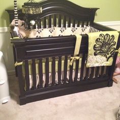 a baby crib in a room with green walls