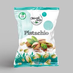 a bag of pistaacho with green leaves and nuts on the side, in front of a gray background