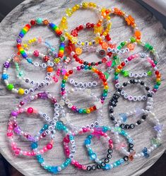 the bracelets are all different colored and have numbers on them, as well as beads