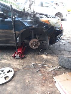 a car that is sitting on the ground with its front wheel removed from it's tire