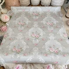 a table topped with lots of different types of fabric