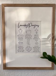 a framed poster hanging on the wall next to a potted plant