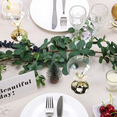 the table is set with silverware, plates, and fruit on it for a festive dinner