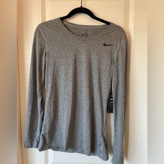 Nike Dri-Fit, Gray, Long Sleeved T-Shirt. Size Small. Never Been Worn. Heather Grey Crew Neck Workout Top, Nike Workout Tops For Fall, Nike Gray Stretch Top, Nike Gray Tops For Fall, Nike Crew Neck T-shirt For Fall, Nike Basic Tops For Fall, Nike Casual Stretch Tops, Basic Nike Tops For Fall, Nike Stretch Crew Neck Tops