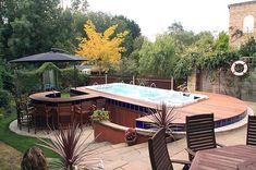 an outdoor hot tub surrounded by patio furniture