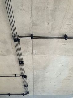 wires are attached to the concrete wall in an area that looks like it's been built