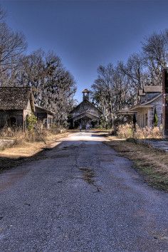 an empty street lined with abandoned buildings