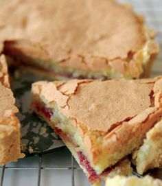 there is a pie that has been cut in half on the cooling rack with one slice taken out