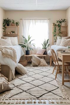 a bedroom with two beds and plants in the window