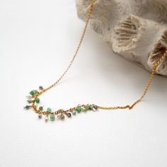 A beautiful handmade subtle necklace, embellished with small, glittering gemstones. The necklace is made of 14k gold filled rolo chain and small blue and green gemstones hang from the chain. The stones are Larimar, apetite, chrysoprase and freshwater pearls. Each stone is made by hand on the chain, making it unique and with a personal touch. The subtle gemstones symbolize the beautiful colors of nature and bring a touch of freshness to your style. The total length of the chain is 45cm and the st Delicate Gold Emerald Necklace Gift, Dainty Gold Emerald Necklace With Delicate Chain, Delicate Gold Emerald Necklace As Gift, Handmade Dainty Emerald Necklaces, Dainty Emerald Necklace With Delicate Chain, Dainty Handmade Necklaces For May Birthstone, Dainty Handmade May Birthstone Necklaces, Gold Beaded Necklaces With Birthstone For Gift, Minimalist Gold Emerald Necklace With Delicate Chain