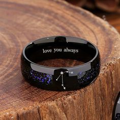 a black bracelet with the words love you always written on it next to a watch