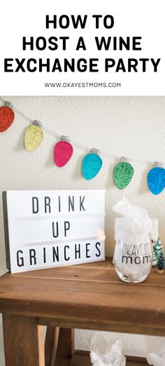 a wooden table topped with wine glasses next to a sign that says how to host a wine exchange party