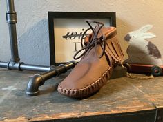 These handmade moccasins will not disappoint.  Crafted of a beautiful whiskey hued finished leather with a pebbled grain. Made completely of leather with a leather insole. This may be substituted for a faux Sherpa insole at no additional cost. Brown Leather Moccasins With Textured Sole, Brown Closed Toe Moccasins With Stitched Sole, Brown Moccasins With Textured Sole And Closed Toe, Brown Closed Toe Moccasins With Textured Sole, Brown Closed-toe Moccasins With Leather Footbed, Brown Closed Toe Moccasins With Leather Footbed, Brown Leather Footbed Moccasins, Artisan Brown Slip-on Moccasins, Fall Brown Textured Sole Moccasins