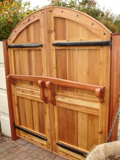 a wooden gate with two black iron bars