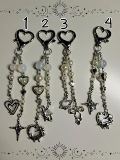 four different charms are hanging on a wall