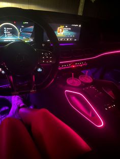 the interior of a car is lit up with neon lights