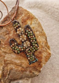 "A rustic and whimsical hand wire wrapped and beaded cactus necklace that would make a great gift for anyone who loves the desert! I wired a mixture of Czech glass beads and flowers in tan and olive green onto the cactus frame for rich color and texture.  The pendant is 2.75 \" long and hangs from an 20\" soft leather cord." Beaded Cactus, Desert Jewelry, Cactus Necklace, Desert Cactus, Rustic Jewelry, Beaded Hoop Earrings, Beaded Hoops, Czech Glass Beads, Heart Earrings