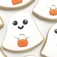 decorated cookies with ghost faces and pumpkins on them