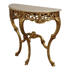 an ornate gold console table with marble top