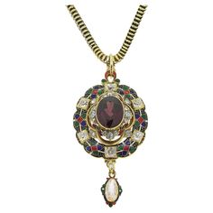 Here we have a stunning antique necklace taken from the personal collection of pop music icon, Sir Elton John. This 18ct yellow gold piece dates back to the Victorian period and showcases a large oval faceted garnet are the centre. This principal stone sits risen at the centre and is accompanied by three trios of rose cut diamonds. Gorgeous enamel work has been expertly carried out around the outer edge in rich red, green, blue, black and white before the piece is finished with individually set Victorian Necklace With 17 Jewels In Oval Pendant, Vintage Oval Pendant Necklaces With 17 Jewels, Vintage Yellow Gold Necklace With Jewels, Vintage Yellow Gold Necklaces With Jewels, Ceremonial Pendant Necklace With Vintage Charm, Antique Temple Necklace With 17 Jewels As Gift, Vintage Ceremonial Necklace With Round Pendant, Vintage Round Pendant Necklace For Ceremonies, Art Nouveau Necklaces