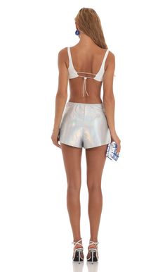 Designed in Los Angeles- Pull-on- Unlined- Made in Iridescent Foil Fabric- Hand wash coldModel is wearing a size small shorts that measures 12in/30cm in lengthSlight modifications might be made to improve garment quality.Handling the garments with care, hand-washing and air-drying is strongly recommended. Metallic Fitted Shorts, Fitted Metallic Shorts, Metallic High-waisted Shorts For Party, Metallic Party Shorts, Metallic Bottoms With Built-in Shorts, Iridescent Bottoms For Summer Party, Fitted Metallic Shorts For Summer, Iridescent Stretch Bottoms For Summer, Metallic High-waisted Shorts For Summer