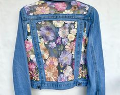 a denim jacket with flowers on it