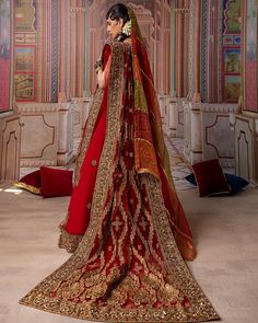 Indian Bridal Lehenga Choli and Dupatta Dress in Red is a breathtaking masterpiece that gives the gorgeous bride a head-turning appearance on the wedding. Lavish designs and luxury embellishments make this beautiful Indian Bridal Wear an epitome of beauty. Bridal Choli The choli is gracefully emblazoned with luxury designs and dabka work. Sleeveless design and classic details make this beautiful bridal choli a perfect choice to pair with Red Lehenga. Indian Bridal Lehenga The Bridal Lehenga is f Red Saree Gown With Dupatta, Red Gown With Dabka Work For Reception, Red Saree Dress For Traditional Ceremonies, Red Gown With Intricate Embroidery And Traditional Drape, Red Gown With Dabka Work Styled As Saree, Red Semi-stitched Gown With Traditional Drape, Traditional Festive Gown With Long Train, Red Wedding Sharara With Traditional Drape, Red Floor-length Sharara For Wedding