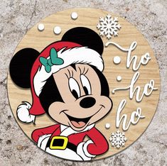 a wooden sign with mickey mouse wearing a santa hat