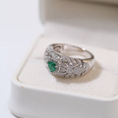 Featuring a heart-shaped emerald centerpiece surrounded by a dazzling halo of diamonds, this delicate ring embodies the essence of vintage elegance. The rich green color of emeralds symbolizes love and vitality, while sparkling diamonds add a touch of glamor. Metal: 18ct Recycled White Gold Plated On Recycled Sterling Silver Gemstone: Cubic Zirconia,Artificial Emerald Gemstone Ring Dimensions: High 10mm Ring Sizes Available: US 6, 7, 8, 9 Weight: 7g Emerald And Diamond Ring, Edison Pearls, Vintage Elegance, Rich Green, Vintage Heart, Ring Sizes, Emerald Gemstone, Delicate Rings, Recycled Sterling Silver