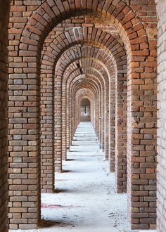 a long brick tunnel lined with benches