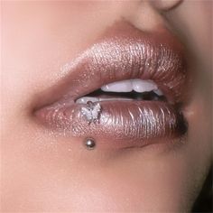 a woman's lips are adorned with silver glitter