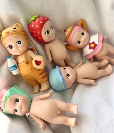 several small toy babies laying next to each other