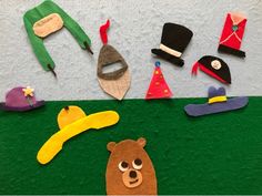 there are many different items made out of felt on the wall, including shoes and hats