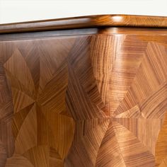 a close up of a wooden cabinet with woodgrain designs on the front and sides