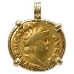 The first of its kind in my shop, a Roman gold Aureus. I cannot find any online shop that sells these set in gold. I see lots of seller charging what I charge for trivial coins (bronze, not gold and large like this one). This stunning coin measures about 19 mm and weighs nearly 7 grams. To appreciate the pendant's size, the relief of the coin and the shape of the bail, see the picture showing the coin next to a US quarter. The coin was first set in a 18k gold bezel, which was then hammered over the edge of both sides. This was then sanded and polished. This pendant is built to last. The pendant feels incredible in hand. The pendant will come with a pendant box and coin information. Bought from a coin dealer in the Netherlands, found in a France. -- Coin information: Nero, gold aureus. Stru Gold Vintage Jewelry For Formal Occasions, Collectible Ancient Style Yellow Gold Jewelry, Ancient Yellow Gold Jewelry For Collectors, Ancient Style Collectible Yellow Gold Jewelry, Ancient Yellow Gold Coin Pendant Jewelry, Ancient Gold Pendant Jewelry, Ancient Style Gold Pendant Jewelry, Gold Antique Pendant Jewelry, Gold Pendant Jewelry In Vintage Style