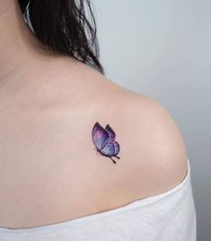 a woman with a purple butterfly tattoo on her shoulder