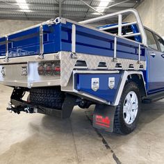 a blue and silver truck parked in a garage