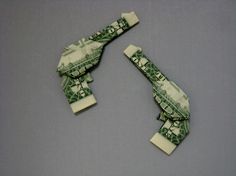 two pieces of money are folded up into the shape of an origami airplane