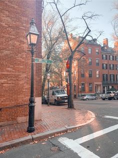 a street light on the corner of a brick building