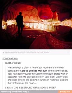 a man standing in the middle of a cave with red light coming from it's mouth